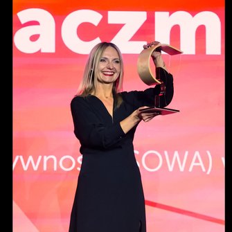 Adrianna Kaczmarek, dyrektorka Rawickiej Biblioteki Publicznej, trzyma nagrodę z uśmiechem.